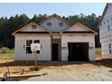 New construction home featuring an attached two-car garage with a front yard and green space in a quiet neighborhood at 362 Bluejay St, Clayton, NC 27520