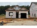 New construction home featuring an attached garage and covered entry, surrounded by a partially landscaped yard at 362 Bluejay St, Clayton, NC 27520