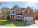 Charming two-story brick home boasts a lush green lawn and inviting curb appeal at 3708 Tansley St, Wake Forest, NC 27587