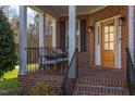 Inviting front porch with comfortable seating, perfect for relaxing and enjoying the outdoors at 3708 Tansley St, Wake Forest, NC 27587