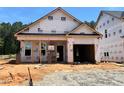 New construction featuring an attached two-car garage and covered entry on a sunny lot at 378 Bluejay St, Clayton, NC 27520