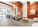 Elegant lobby with couches, chairs, artwork, pendant lighting, and large windows for natural light at 400 W North St # 1204, Raleigh, NC 27603