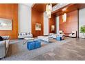 Grand lobby with wood paneled walls, comfortable seating, pendant lights, and marble flooring at 400 W North St # 1204, Raleigh, NC 27603