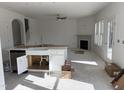 Bright, unfinished kitchen with a farm sink, stainless steel appliances, an island, and fireplace views at 4005 Kingcraig Ln, Zebulon, NC 27597