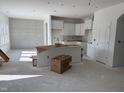 Spacious kitchen featuring white cabinetry, a center island, and a well-lit area with natural light at 4005 Kingcraig Ln, Zebulon, NC 27597