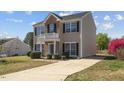 Charming two-story home featuring a well-maintained lawn and inviting curb appeal at 409 Sapphire Dr, Durham, NC 27703