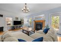 Inviting living room features a fireplace, large sectional sofa, natural light, and hardwood floors at 445 S Greensboro St, Carrboro, NC 27510