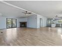 Spacious living room with fireplace, hardwood floors, ceiling fan, and natural light at 471 Deer Run, Pittsboro, NC 27312