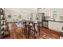 Bright open-concept living space with modern kitchen, hardwood floors, and stylish furnishings at 613 Canal St, Durham, NC 27701