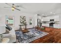 Open-concept living room and kitchen featuring stainless steel appliances, and hardwood floors at 613 Canal St, Durham, NC 27701