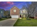Charming two-story home with brick and siding, a well-manicured lawn, and colorful landscaping at 6817 Osprey Landing Dr, Wendell, NC 27591