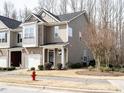 Exterior view of a well-maintained townhouse with a tidy front yard at 700 Treviso Ln, Apex, NC 27502