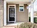 Close-up of a welcoming front door with decorative wreath and sidelight window at 700 Treviso Ln, Apex, NC 27502