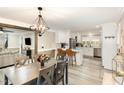 Open concept showcases modern dining area leading to a well-equipped kitchen, perfect for entertaining at 703 Sybil Dr, Durham, NC 27703