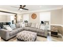 Bright living area featuring a large gray sectional, wood floors, and natural light at 703 Sybil Dr, Durham, NC 27703