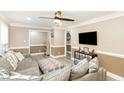 Comfortable living room with a gray couch, large ottoman, and neutral color scheme at 703 Sybil Dr, Durham, NC 27703