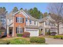 Beautiful two-story home with brick and siding, showcasing a well-maintained lawn and landscaping at 7920 Leonardo Dr, Durham, NC 27713