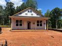 New construction home exterior featuring a front porch and large windows under a blue sky at 87 Legolas Ct, Middlesex, NC 27557