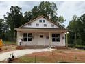 New construction home showcasing a covered porch and a simple facade in a natural wooded setting at 87 Legolas Ct, Middlesex, NC 27557