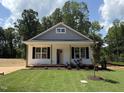 Charming single-story home featuring a well-manicured lawn and classic architectural details and landscaping at 87 Legolas Ct, Middlesex, NC 27557