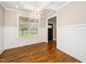 Elegant dining room with hardwood floors, a chandelier, and large windows offering views of the outdoors at 913 Clayton Rd, Angier, NC 27501