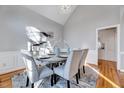 Bright dining room with modern chandelier, light gray walls, and hardwood flooring at 100 Pebble Ridge Farms Ct, Cary, NC 27513