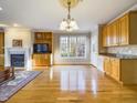 Open concept living room includes hardwood floors, a fireplace, and a cozy, inviting atmosphere at 101 Sundance Pl, Chapel Hill, NC 27514