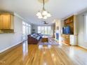 Bright living room features hardwood floors, a fireplace, and large windows offering abundant natural light at 101 Sundance Pl, Chapel Hill, NC 27514