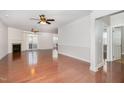 Bright living room with hardwood floors, ceiling fans, fireplace, and sliding glass doors to the outdoors at 10411 Rosegate Ct # 202, Raleigh, NC 27617
