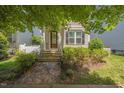 Inviting front exterior featuring a stone pathway leading to the entrance, surrounded by lush greenery and well-maintained landscaping at 105 Della St, Chapel Hill, NC 27516