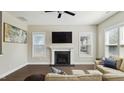 Comfortable living room with hardwood floors, fireplace, and natural light at 105 Della St, Chapel Hill, NC 27516