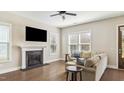 Inviting living room with fireplace, sofa, and abundant natural light at 105 Della St, Chapel Hill, NC 27516
