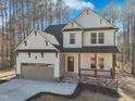 Charming two-story home featuring white siding, a gray roof, and a two car garage at 109 Mohawk Dr, Louisburg, NC 27549