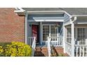 Close up of entrance and covered porch area with red front door at 1101 Esher Ct, Raleigh, NC 27609
