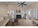 Bright living room boasts a fireplace, neutral carpet, ceiling fan and natural light at 1101 Esher Ct, Raleigh, NC 27609