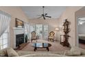 Inviting living room featuring a fireplace, fan, and French doors to an outdoor space at 1101 Esher Ct, Raleigh, NC 27609