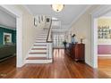 Elegant foyer with hardwood floors, staircase, and a view of French doors at 1106 Aycock Ave, Burlington, NC 27215