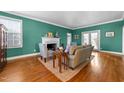 Cozy living room with a fireplace, neutral furniture, and hardwood floors at 1106 Aycock Ave, Burlington, NC 27215