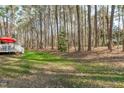Spacious backyard surrounded by a wooded area, as seen from the home's deck at 11808 Black Horse Run, Raleigh, NC 27613