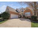 Beautiful brick home with a two-car garage, meticulously landscaped yard, and inviting front entry at 1217 Wedgeland Dr, Raleigh, NC 27615
