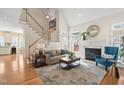Cozy living room with a fireplace, neutral-toned sofa, area rug, and staircase at 1217 Wedgeland Dr, Raleigh, NC 27615