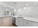Bright kitchen featuring white cabinetry, quartz countertops, and stainless steel appliances at 1226 Coach Station Alley # 101, Raleigh, NC 27601