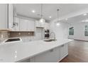 Bright kitchen featuring white cabinetry, quartz countertops, and stainless steel appliances at 1226 Coach Station Alley # 101, Raleigh, NC 27601