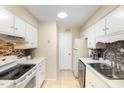 Efficient kitchen with white appliances and cabinets, offering ample counter space and a light-filled atmosphere at 1245 Schaub Dr, Raleigh, NC 27606