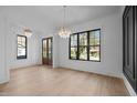 Inviting dining space with natural light, hardwood floors, and modern chandeliers, ideal for Gathering gatherings at 1318 Ivy Ln, Raleigh, NC 27609