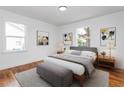 Bright bedroom with hardwood floors, neutral bedding, and ample natural light at 1409 Ida St, Durham, NC 27705