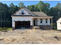 Under construction, this new home displays brick accents and a two-car garage ready to be completed with your personal touch at 151 Tigris Ct, Zebulon, NC 27597