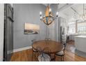 Cozy dining room featuring modern decor, chandelier, hardwood floors and a stylish design at 1535 Caraleigh Mills Ct # 105, Raleigh, NC 27603