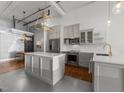 Modern kitchen with stainless steel appliances, island, and unique flooring at 1535 Caraleigh Mills Ct # 105, Raleigh, NC 27603
