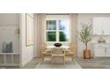 Cozy dining area with a round table, seating for four, large bright window, and stylish decor at 1573 Goldfinch Perch Ln, Knightdale, NC 27545